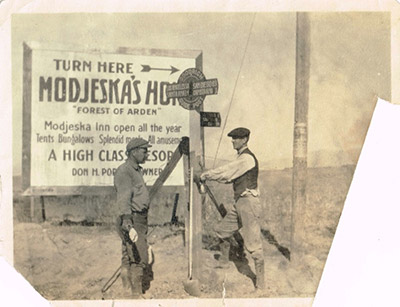 Lamb (left) marking roads for the B.F. Goodrich company ca. 1920